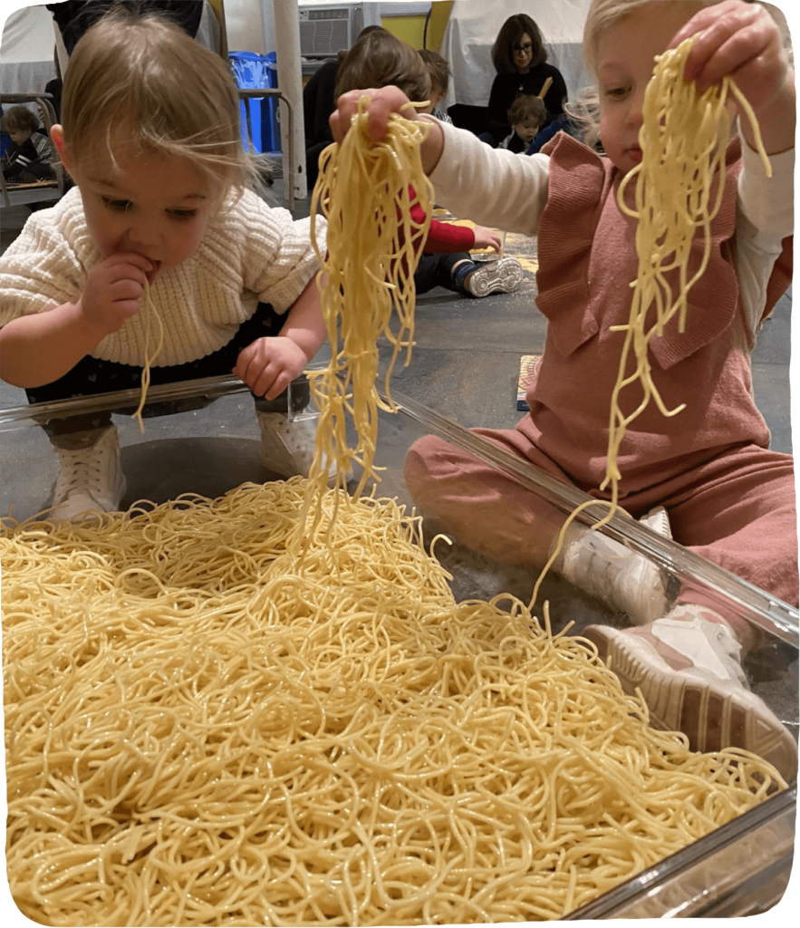 Activity ideas for play with food- two toddlers playing with wet spaghetti
