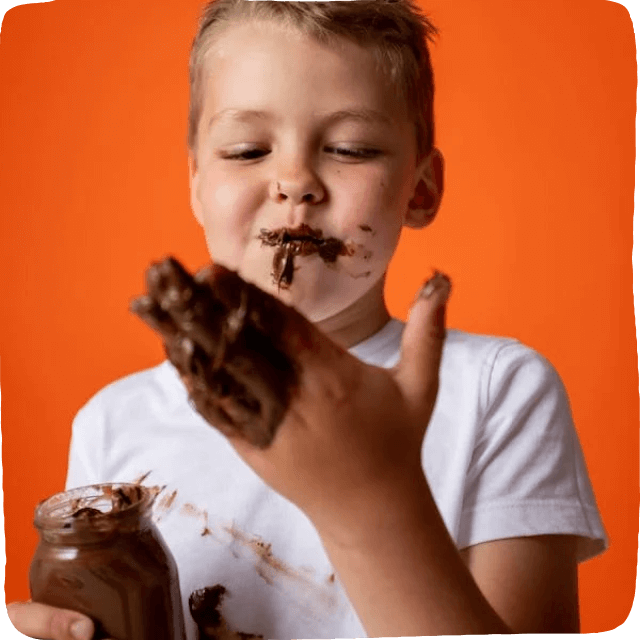 boy with messy face and hands covered in chocolate