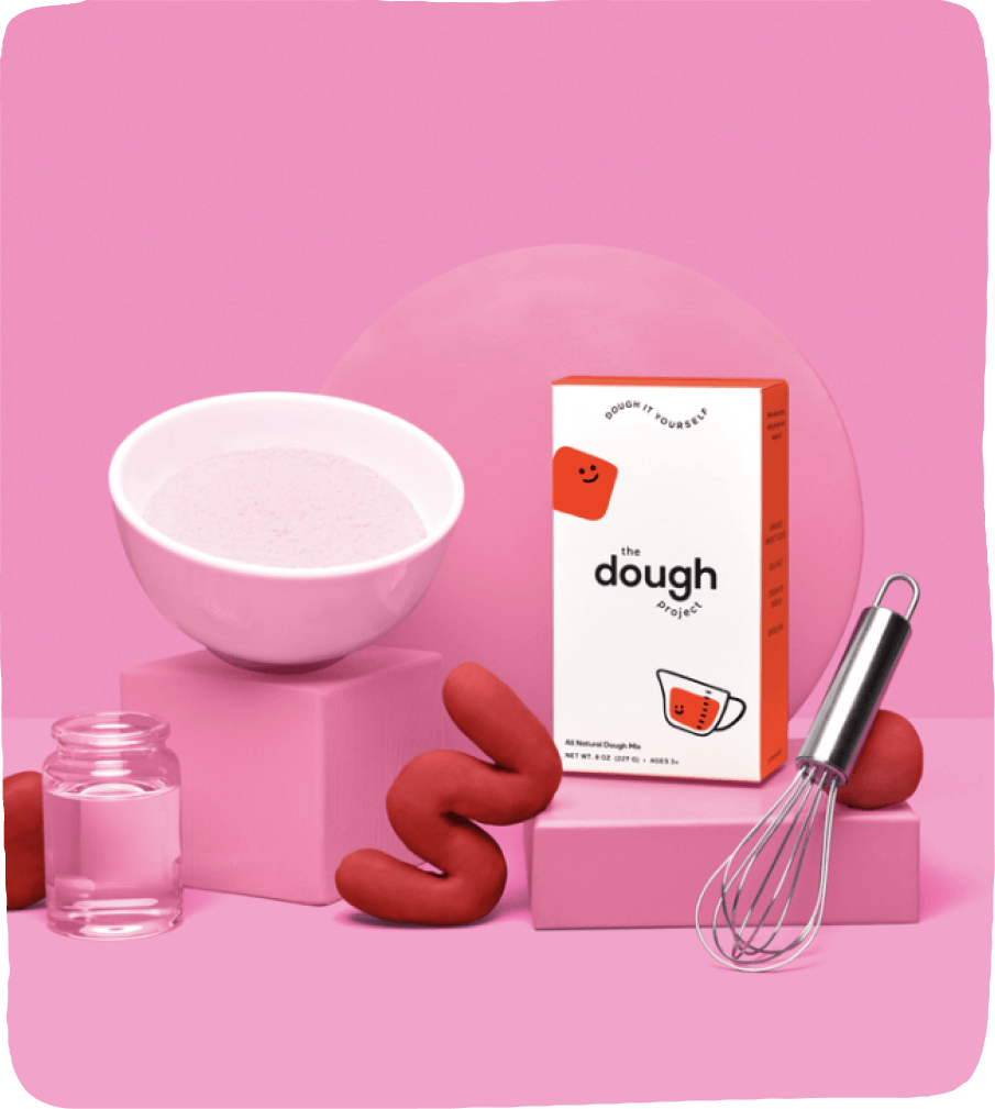 Image of The Dough Factory's play-dough kit, a whisk, and a wiggly piece of play-dough for use in this play-dough activity for kids.