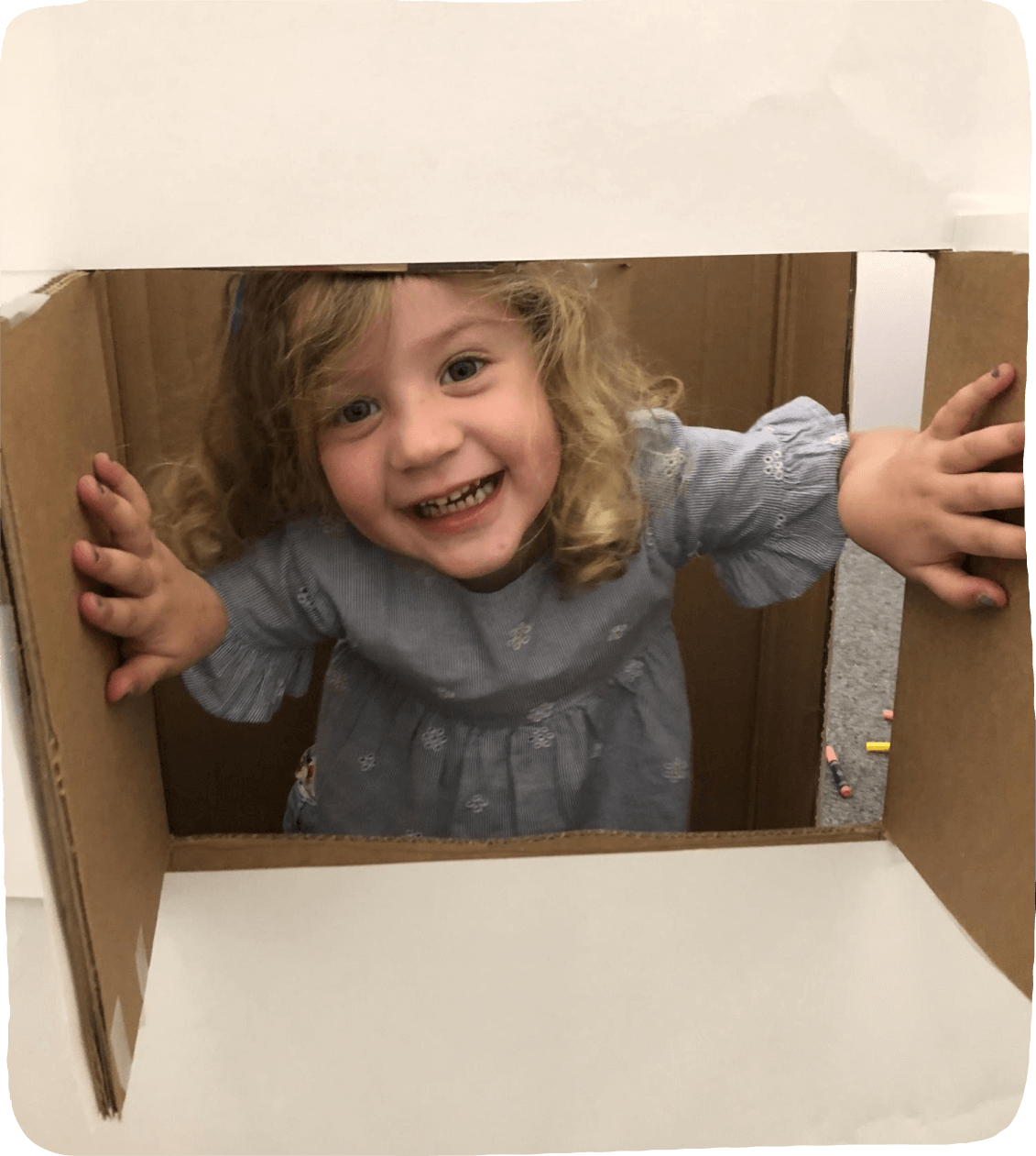 A girl peeking through a window cut into a large cardboard box The Value of cardboard box Play. 
