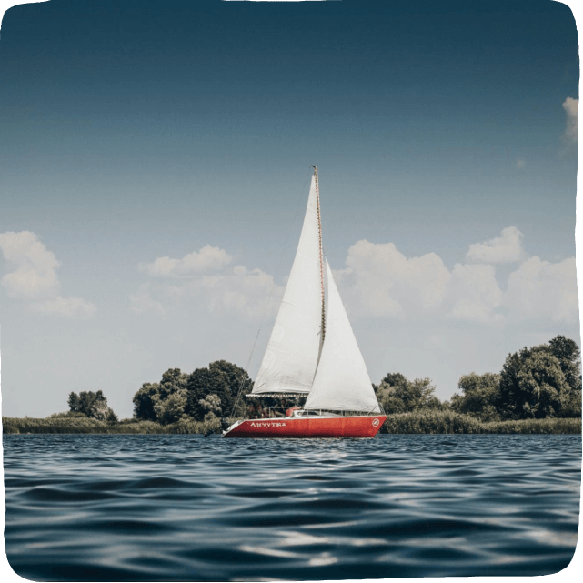 Image of a sailboat on a lake to inspire STEM Activity: build your own toy boat.