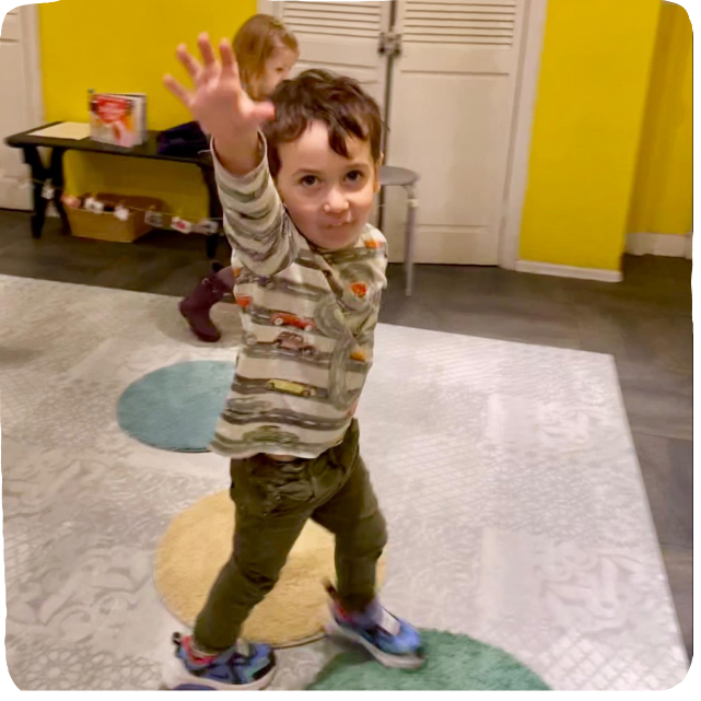 Little boy raising his hand and dancing
