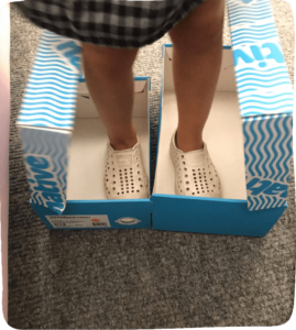 Little feet in shoe boxes pretending they are skates to The Value of cardboard box