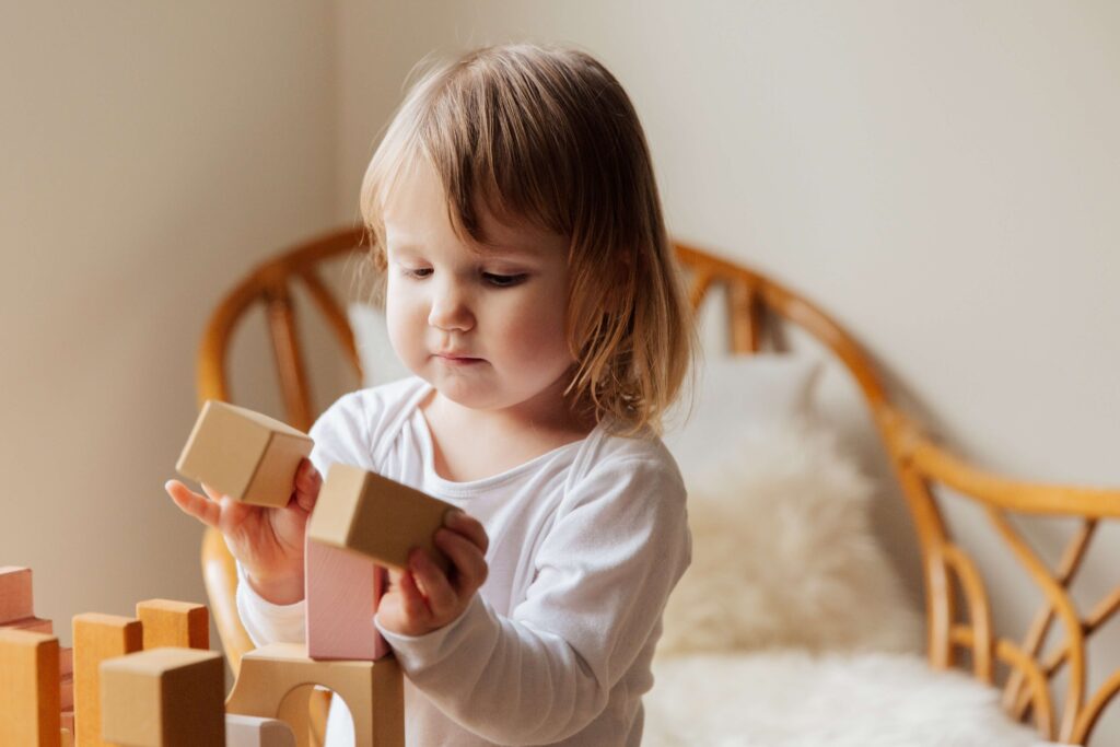 small girl holding blocks in her hands
