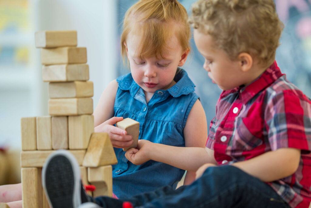 Boy and girl playing with blocks