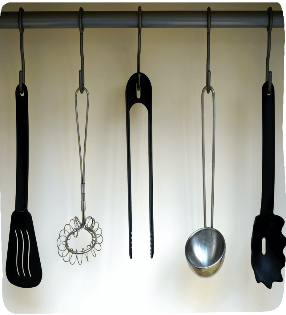 Image of kitchen tools hanging to inspire these fun pretend activities for kids. 