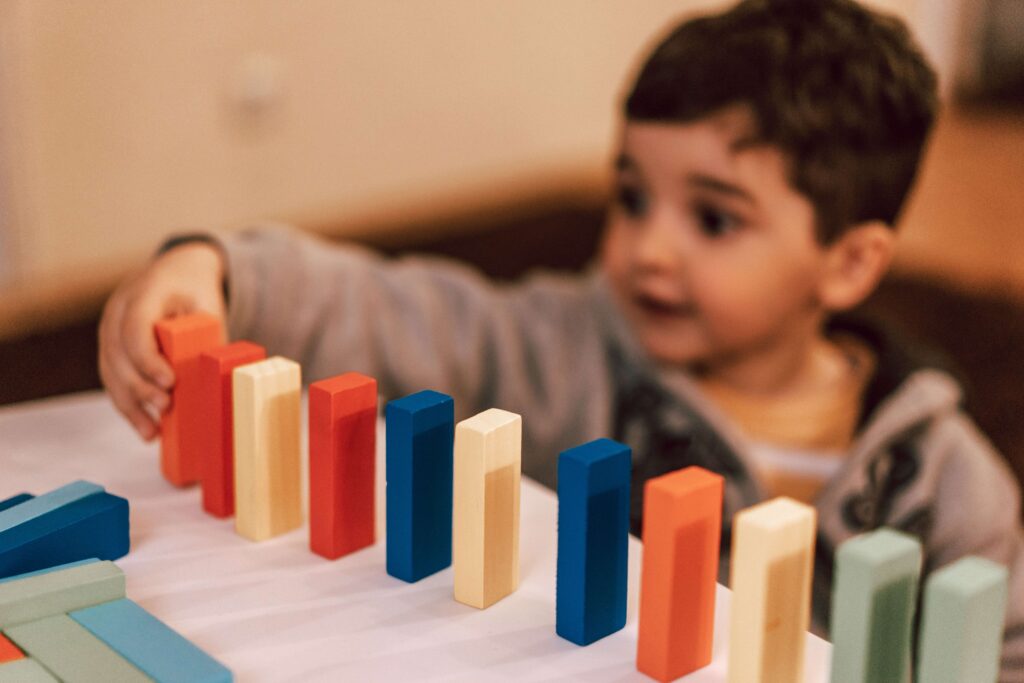 Little boy playing with wooden blocks