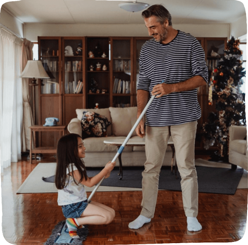 Dad playing with daughter by pushing her as she rides on a broom for kids learning activities chores